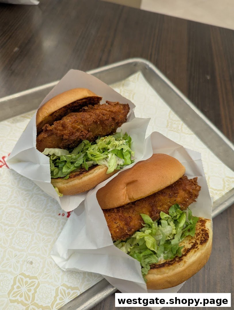 Two crispy fried chicken sandwiches with lettuce on a tray.