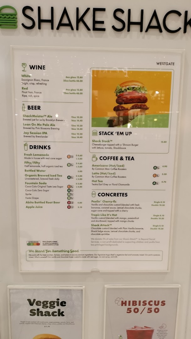 A detailed menu board displaying food, drink, and dessert options at Shake Shack Westgate.