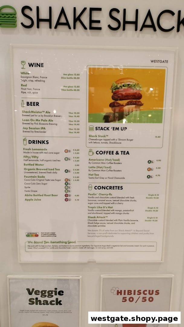A detailed menu board displaying food, drink, and dessert options at Shake Shack Westgate.