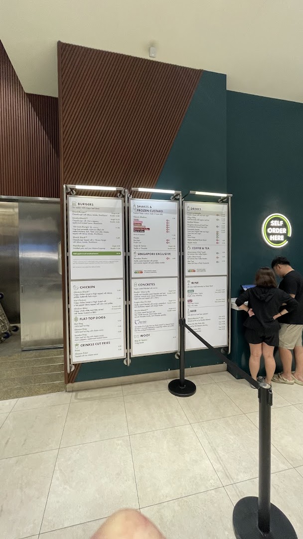 A large menu board displaying burgers, shakes, drinks, and more at Shake Shack.