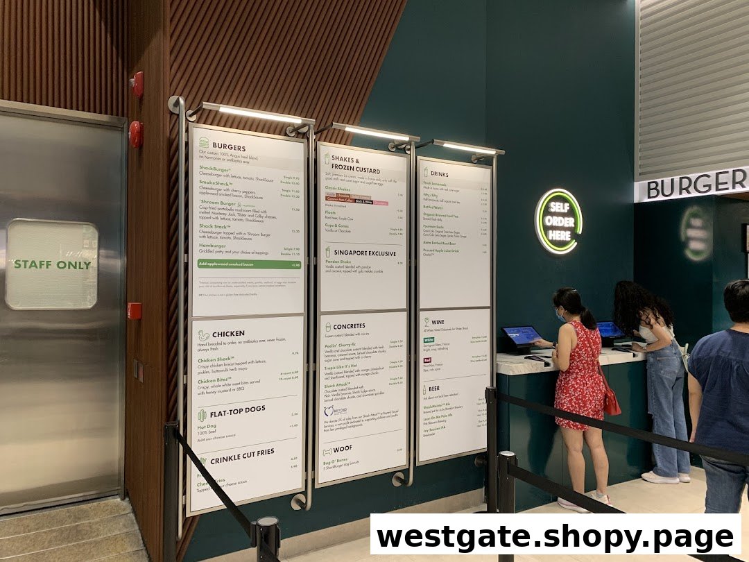 Digital menu boards and self-order kiosks at Shake Shack, showcasing their full range of burgers, shakes, and more.
