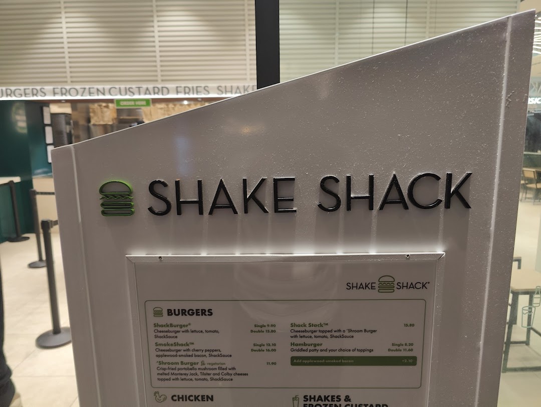 A Shake Shack menu board displaying various burger options and prices.
