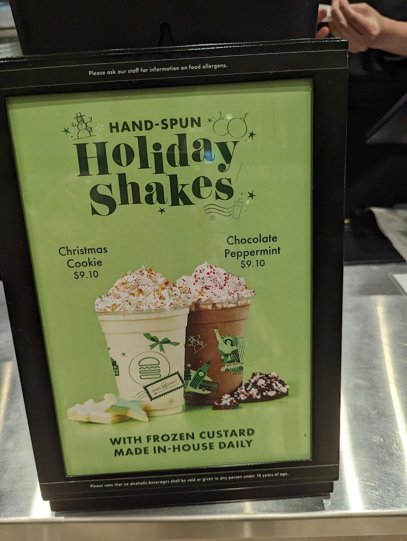 A display board showcasing Shake Shack's festive hand-spun Holiday Shakes with prices.