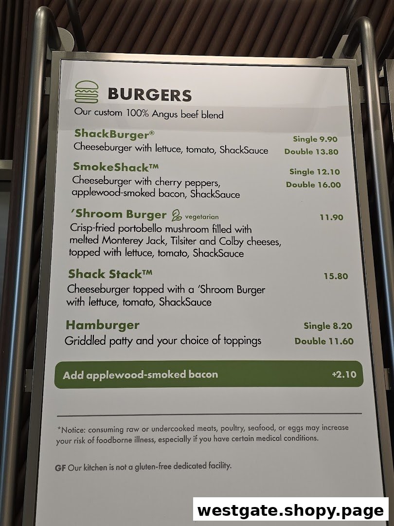 A close-up view of the Shake Shack menu board displaying various burger options and prices.