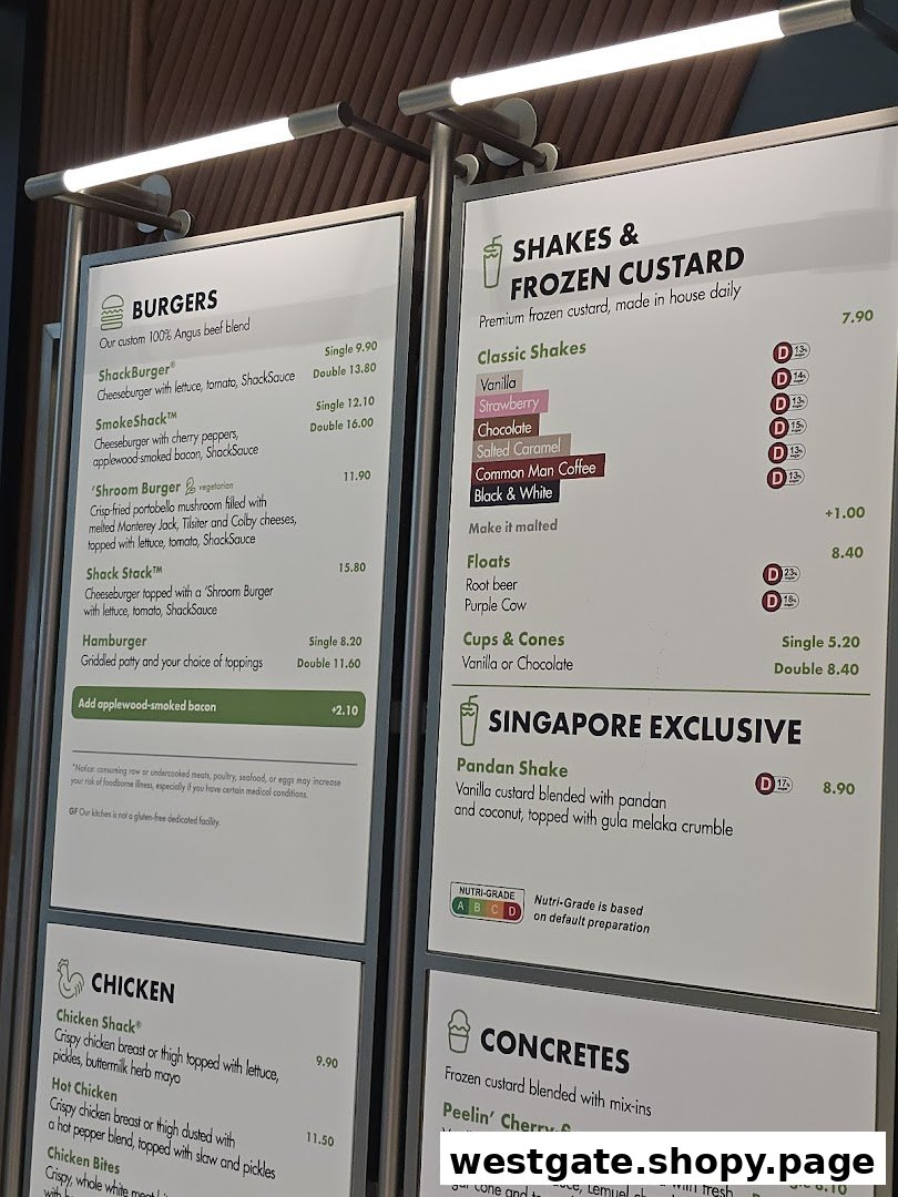 A detailed menu board displaying burgers, shakes, chicken, and concretes with prices.