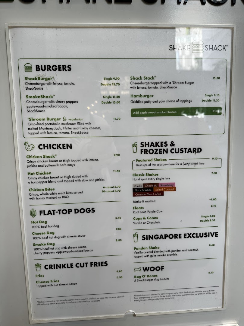 A detailed menu board for Shake Shack, displaying various burgers, chicken, hot dogs, fries, shakes, and desserts.