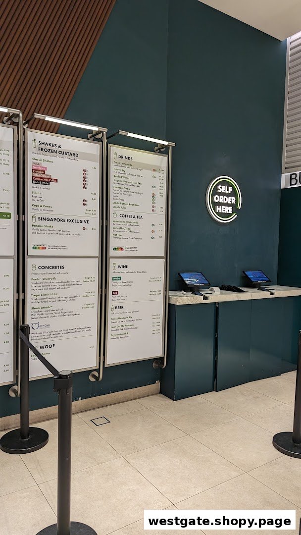 Shake Shack's menu boards displaying shakes, concretes, drinks, and self-order kiosks.