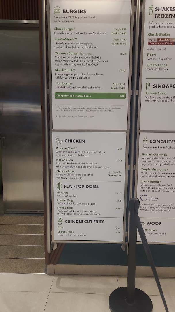 A detailed menu board displaying food and drink options at Shake Shack.