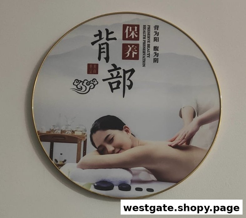 A circular wall art piece featuring a woman receiving a back massage, with traditional Chinese wellness text.