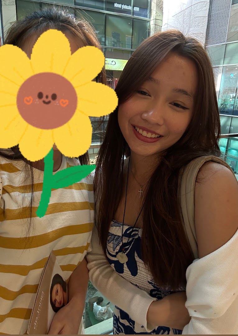 Two young women, one smiling, possibly customers or staff, in a bright indoor setting.