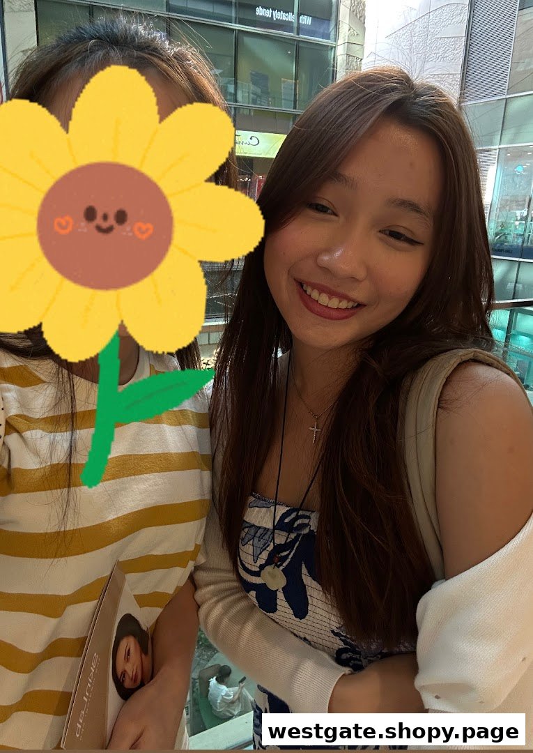 Two young women, one smiling, possibly customers or staff, in a bright indoor setting.