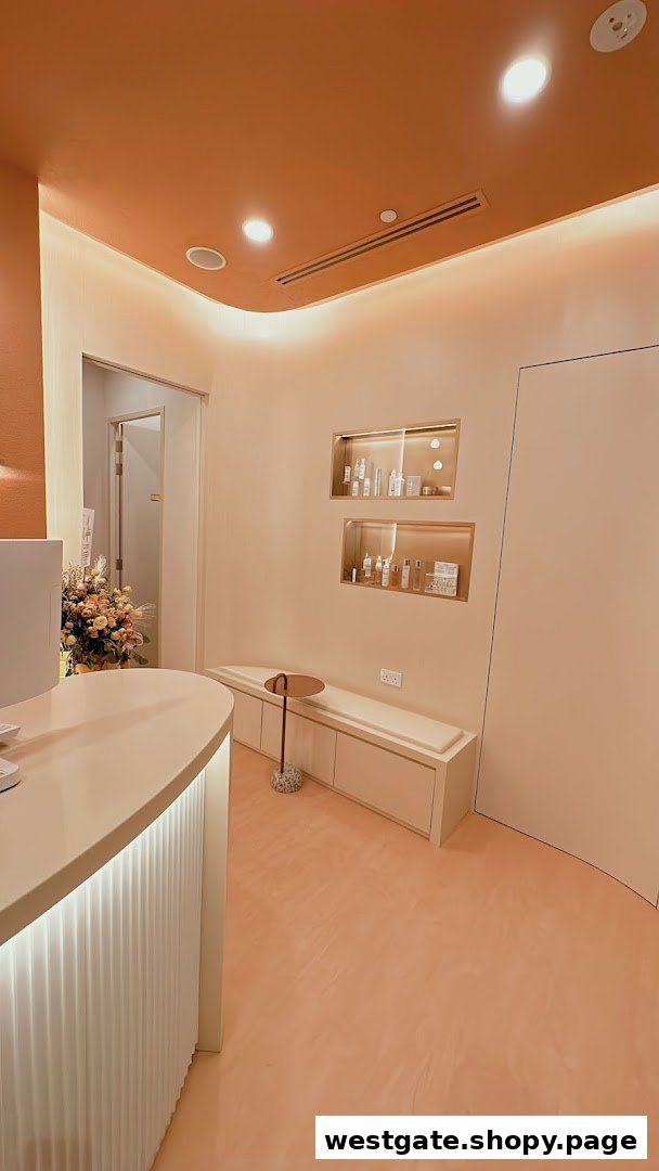 A modern, peach-toned reception area with a curved counter, seating, and product displays.
