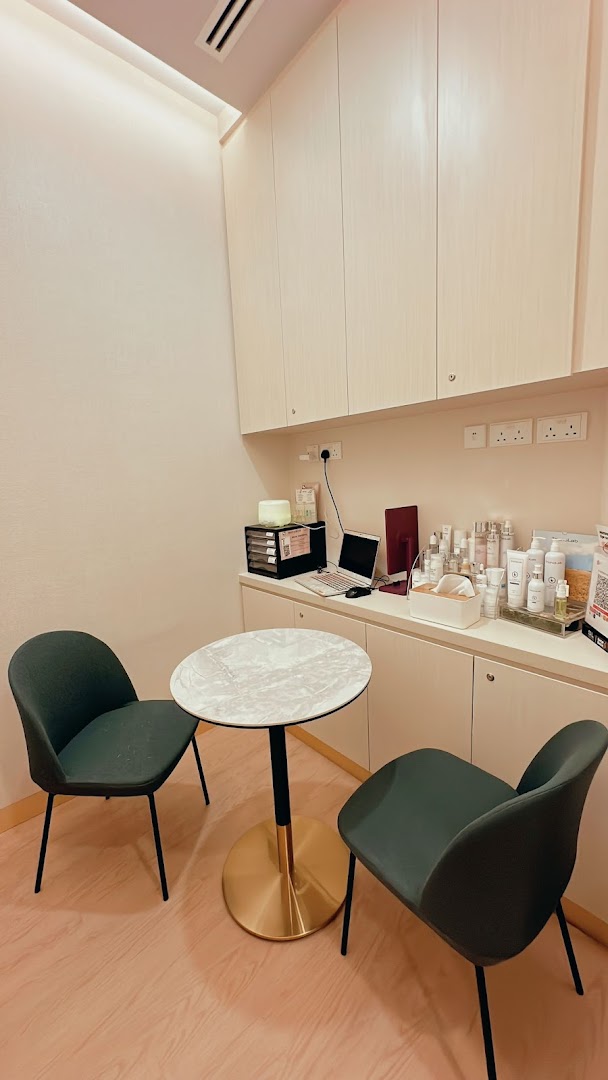 A modern and clean consultation area within SL Aesthetic Clinic, featuring comfortable seating and skincare products.