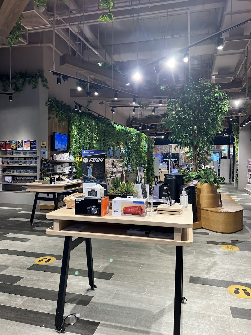 Interior view of a modern Sony Store featuring product displays, green decor, and spacious layout.