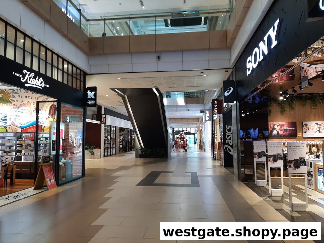 A view of the Sony Store and other retail outlets along a bright shopping mall corridor.