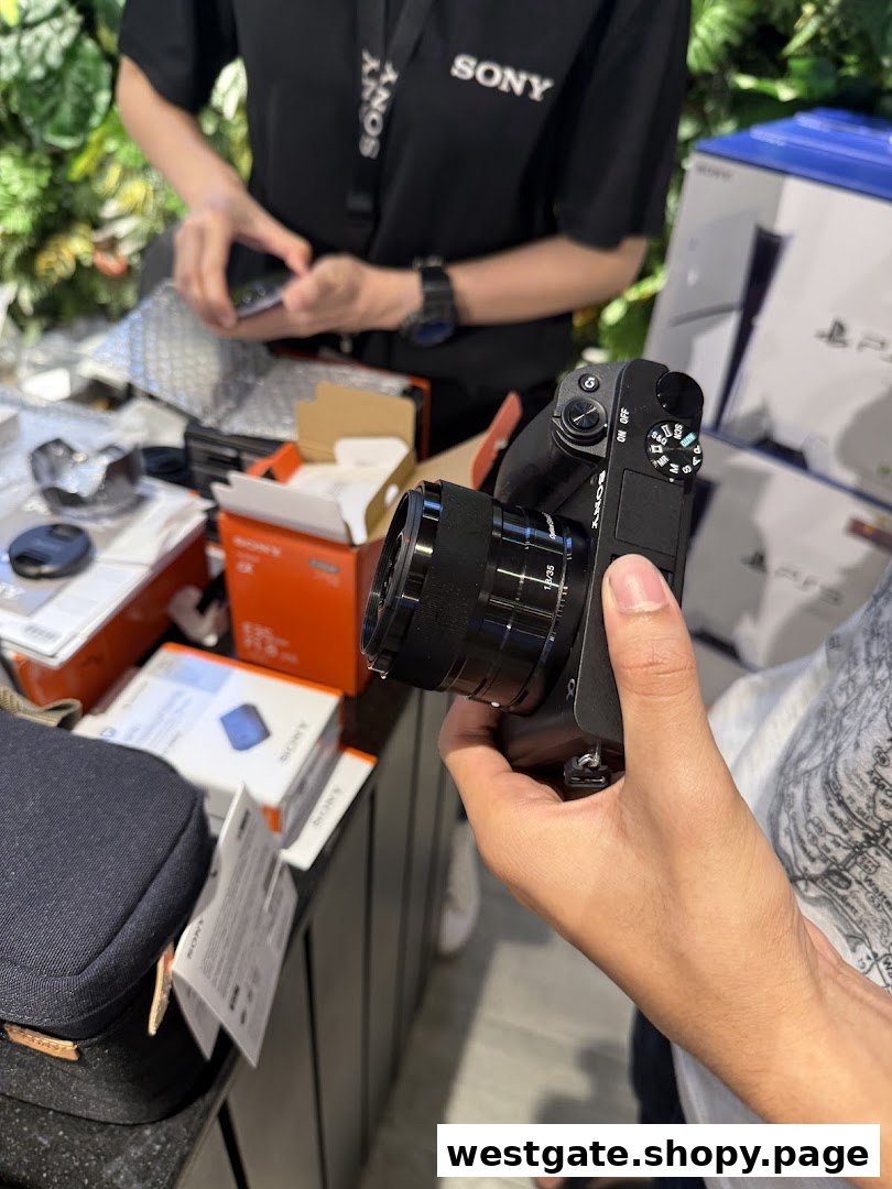 A customer holds a Sony camera while a staff member assists at the counter, surrounded by Sony products.