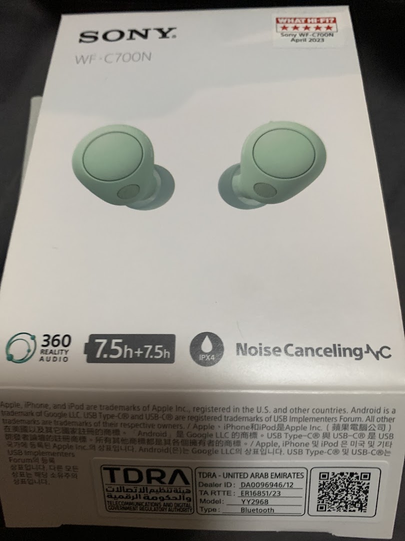 Close-up of a Sony WF-C700N wireless earbuds product box in light green.