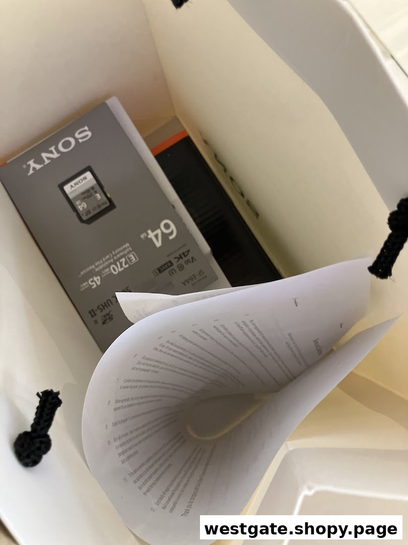 A Sony memory card and documents inside a shopping bag, representing a recent purchase.