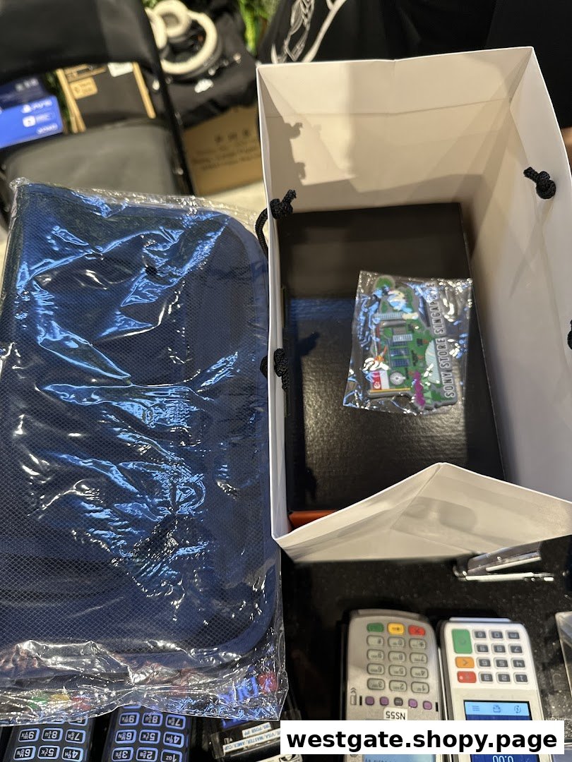 Items purchased from Sony Store, including a blue bag and a Sony Store Singapore souvenir, next to payment terminals.