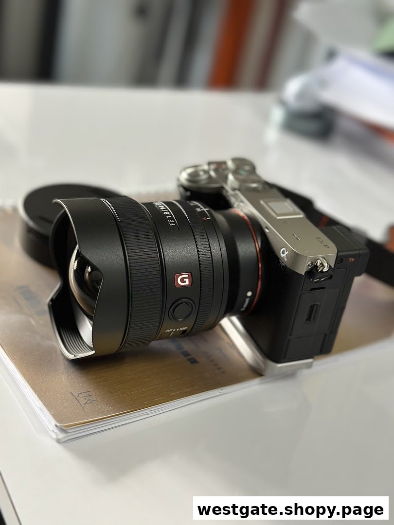 A close-up of a Sony mirrorless camera with a wide-angle lens on a desk.