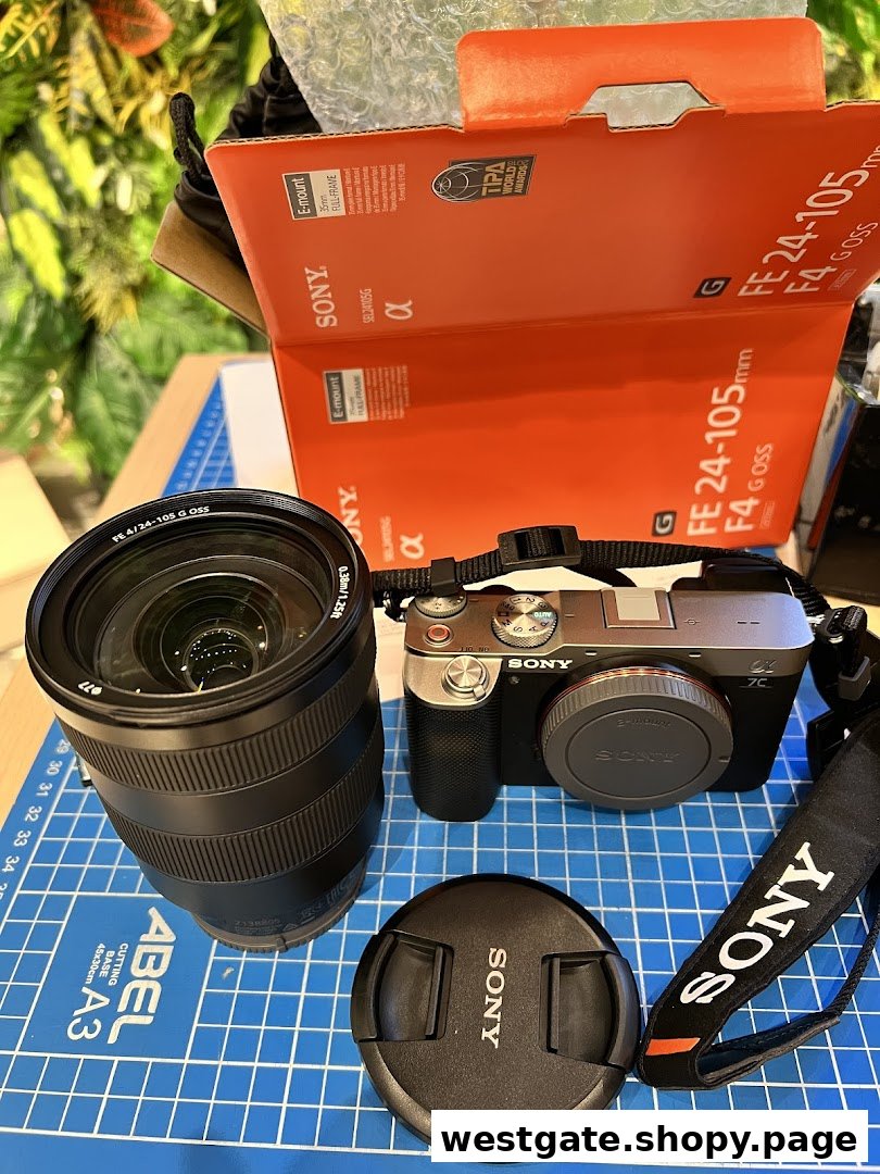 A new Sony Alpha camera, FE 24-105mm G OSS lens, and packaging are displayed on a cutting mat.