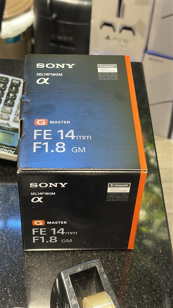A Sony G Master FE 14mm F1.8 GM lens box displayed on a counter.