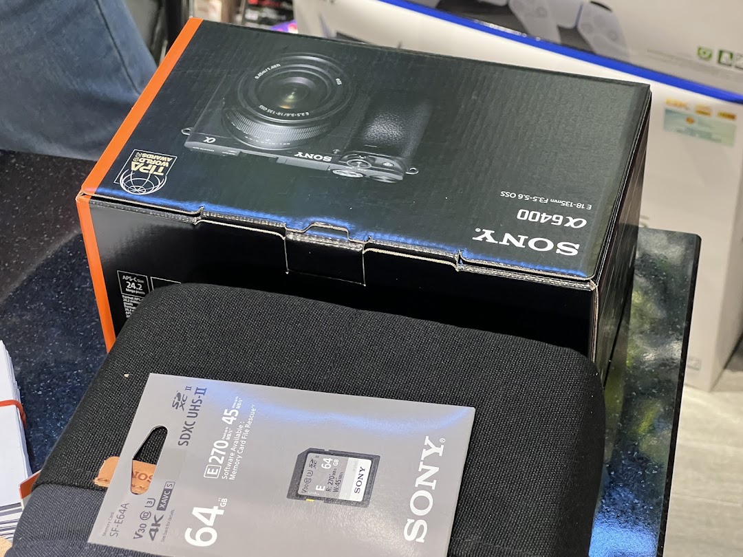 Close-up of a Sony a6400 camera box and a Sony SD card, showcasing electronics products.