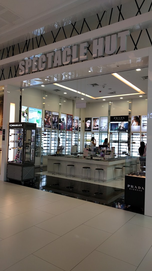 The brightly lit entrance of Spectacle Hut, showcasing a wide range of eyewear and prominent brand displays.