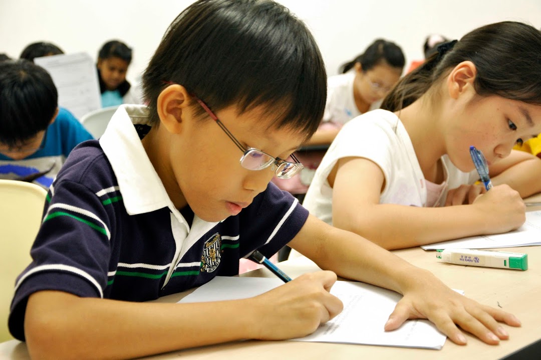 Students diligently writing and studying in a bright classroom at Stalford Learning Centre.