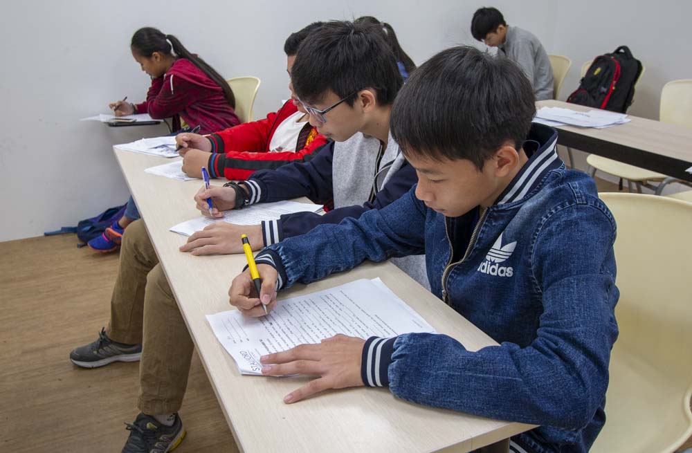 Students are diligently writing and studying in a classroom at Stalford Learning Centre.