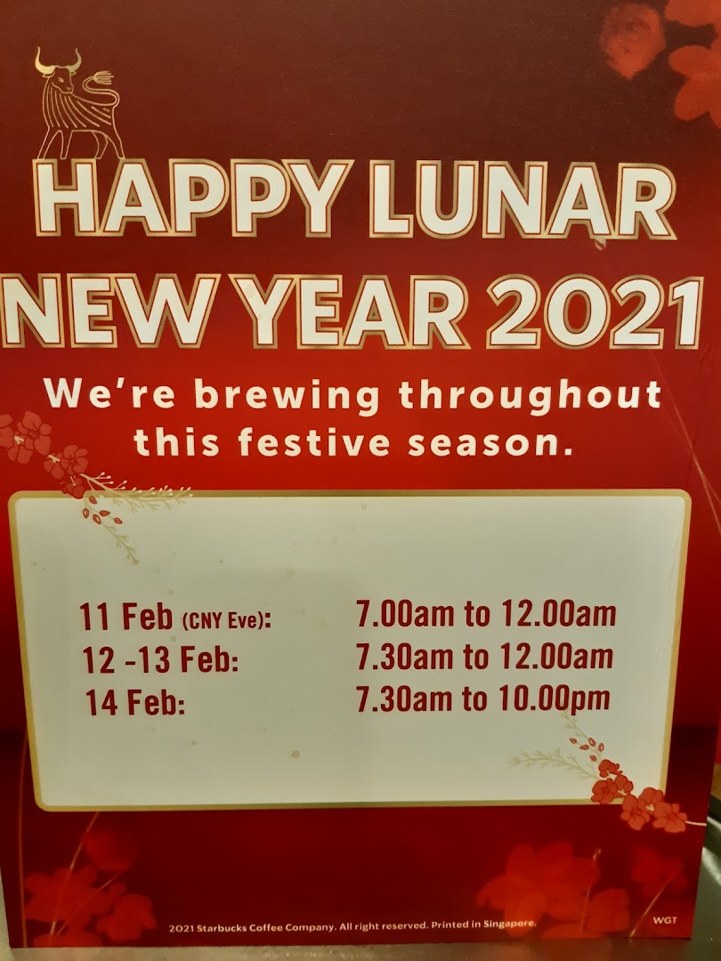 A Starbucks sign wishing Happy Lunar New Year 2021 and listing special festive operating hours.