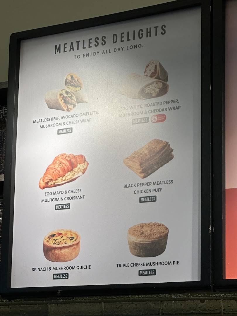 A menu board displaying Starbucks' 'Meatless Delights' food items with images.