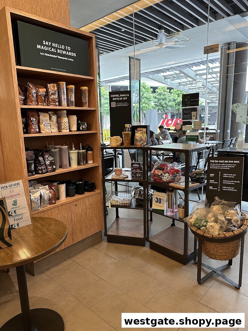 Starbucks interior featuring merchandise shelves, a seating area, and a view through large glass windows.