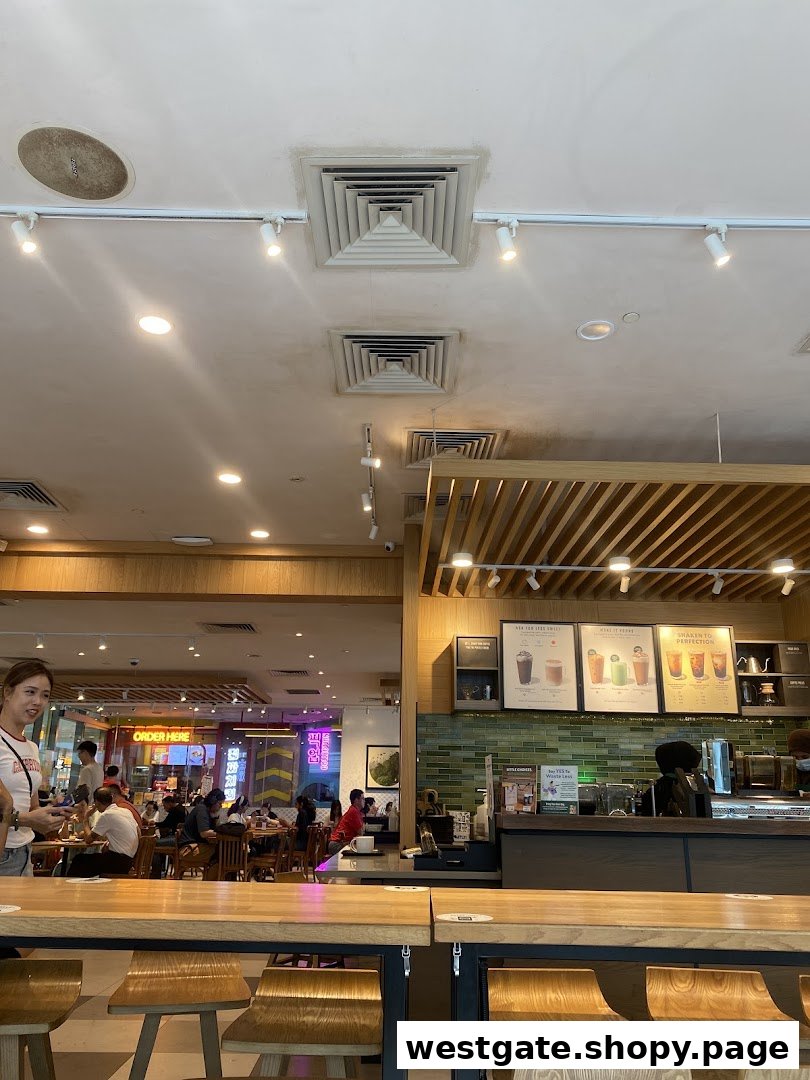 Interior view of Starbucks Westgate, showing the counter, seating area, and customers.