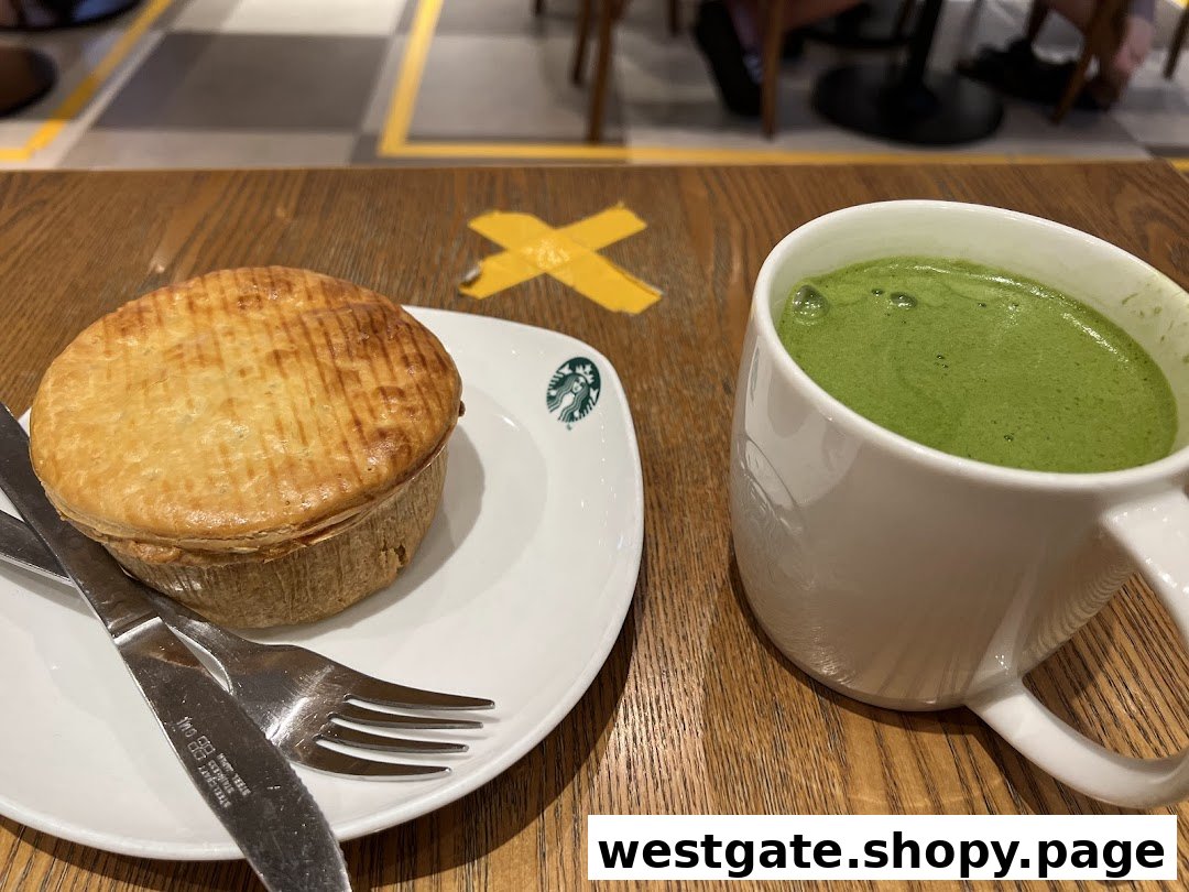 A golden-brown pie and a green matcha latte on a wooden table at Starbucks.