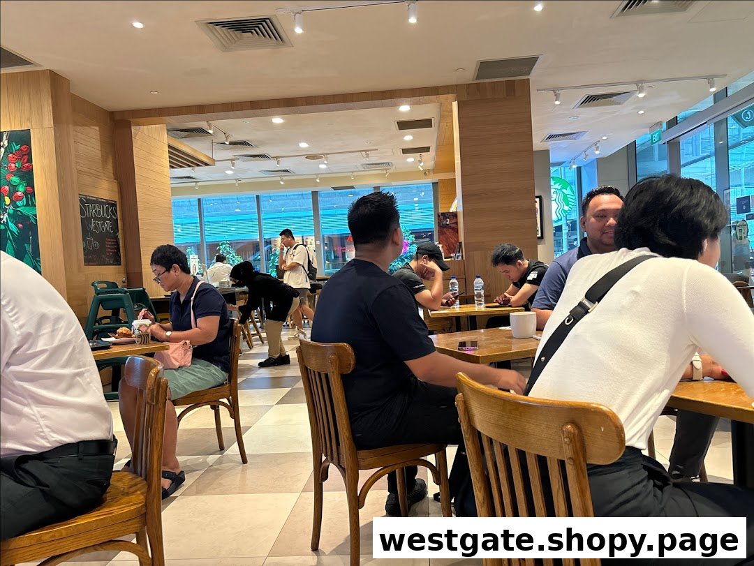 Customers enjoying coffee and conversation inside Starbucks Westgate, a bustling cafe environment.
