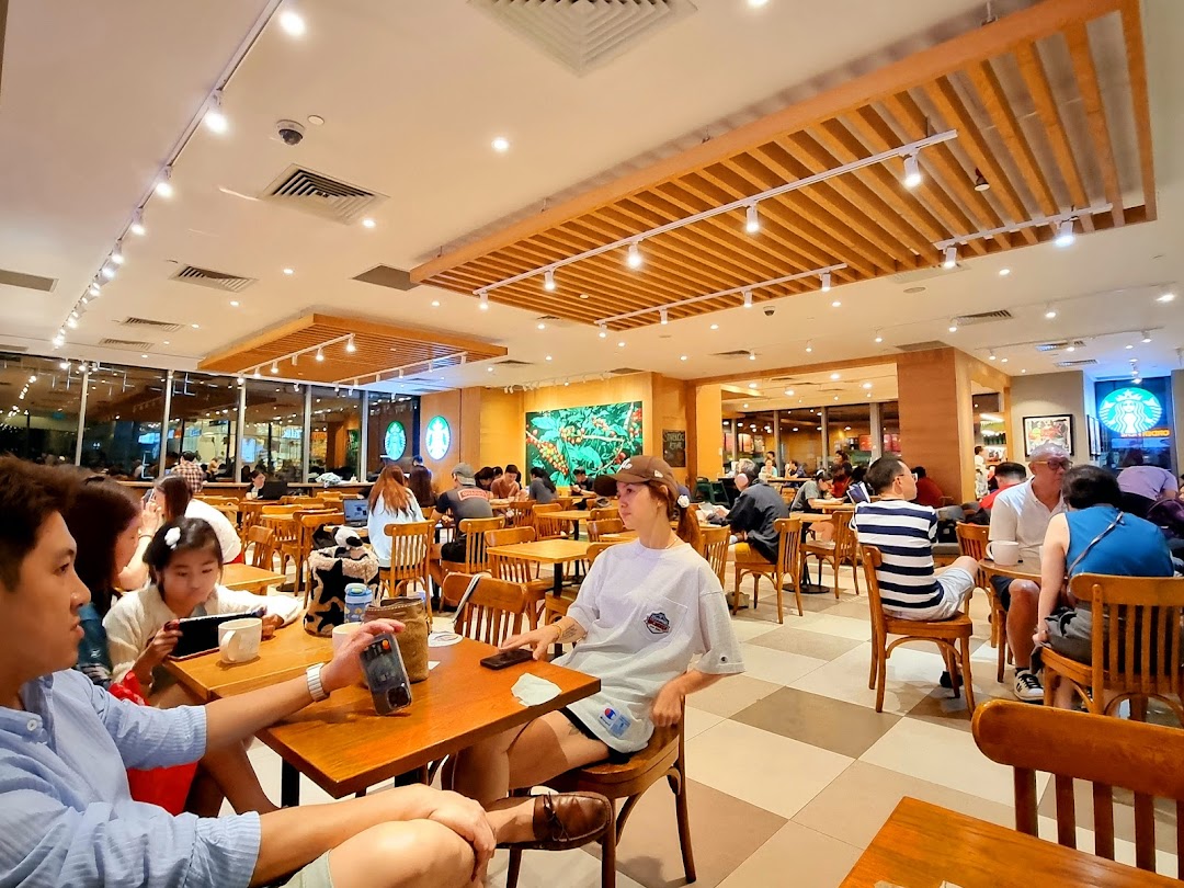 A bustling interior view of Starbucks Westgate with customers enjoying coffee and conversation.