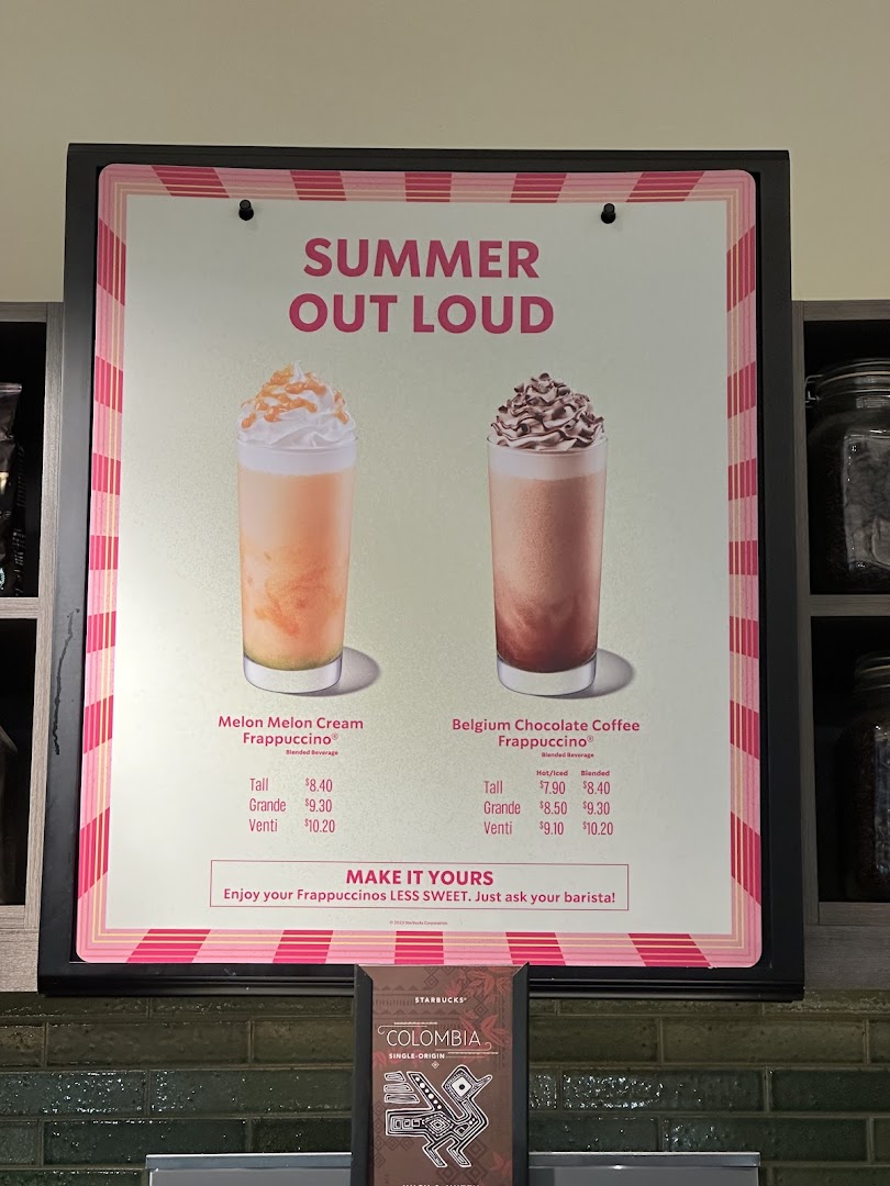 A Starbucks menu board showcasing 'Summer Out Loud' Frappuccinos with prices.