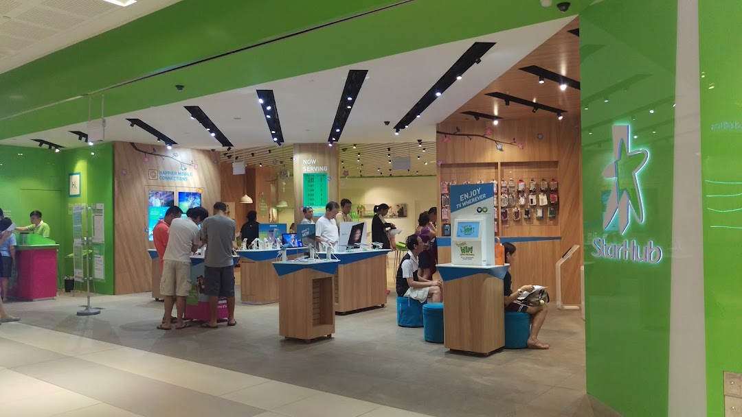 An interior view of the StarHub Westgate store, featuring customers browsing mobile devices and accessories.