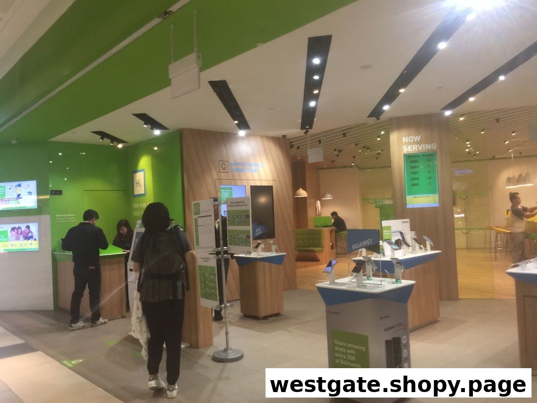 Interior view of StarHub Westgate, featuring customer service counters, mobile device displays, and customers.