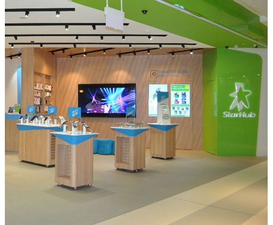 Interior view of StarHub Westgate, showcasing mobile devices, smart home solutions, and vibrant green branding.