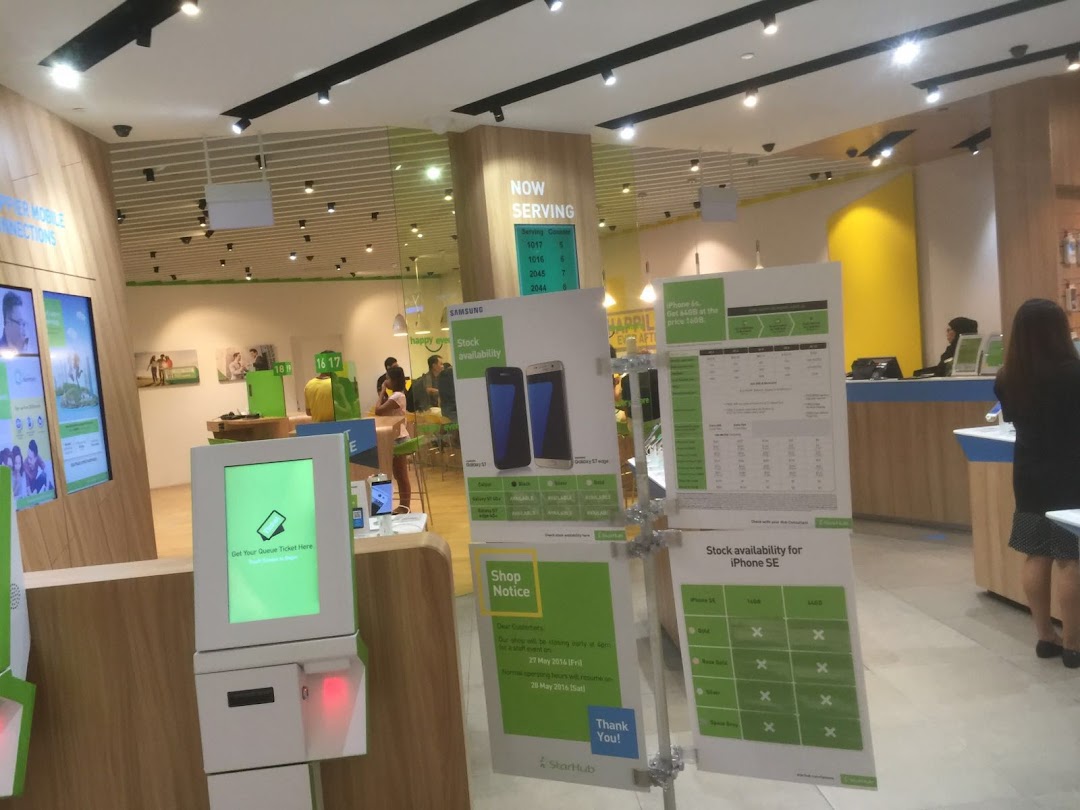 Interior view of StarHub Westgate, showcasing mobile service displays, a queue system, and customer service areas.