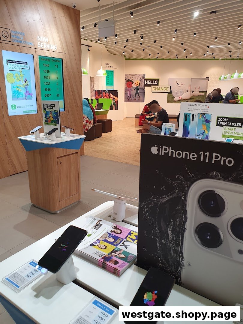 Interior view of StarHub Westgate, showcasing mobile phones, service counters, and customers browsing.