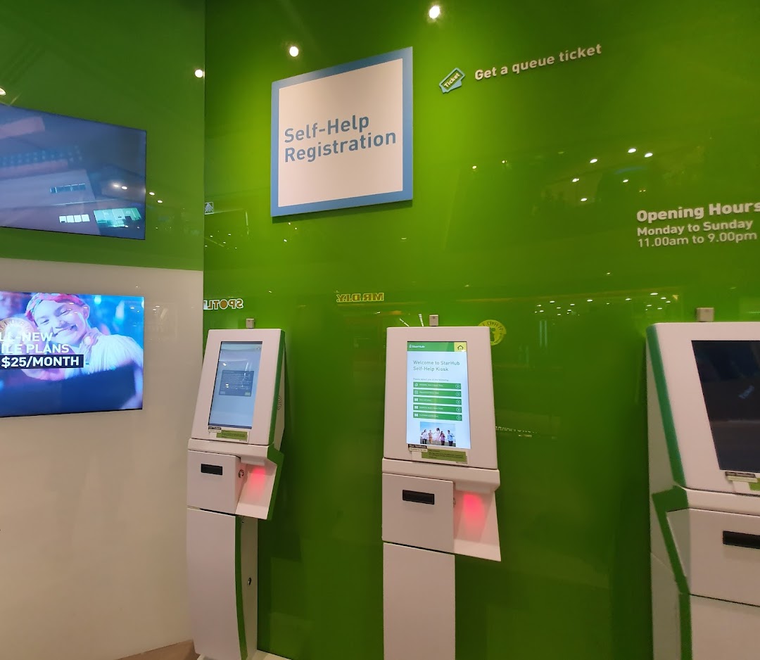 Interior view of StarHub Westgate featuring self-help kiosks and digital displays for customer convenience.
