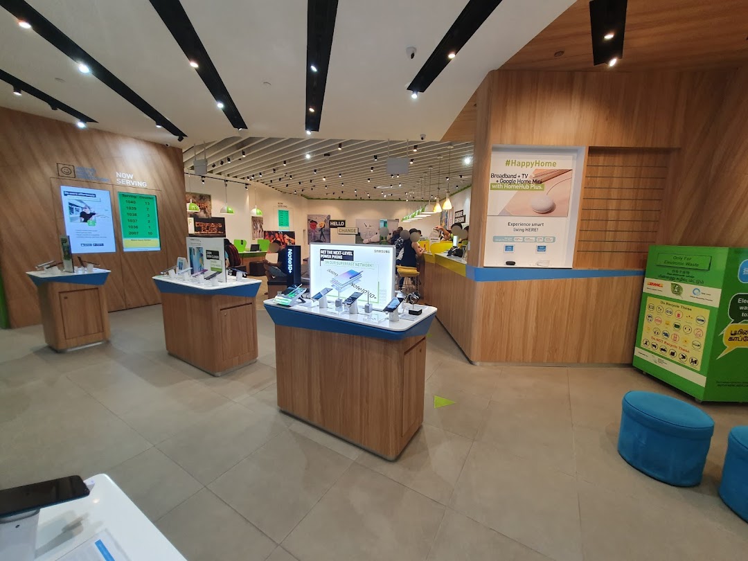 Interior view of a StarHub telecommunications shop featuring display tables, service counters, and promotional signage.