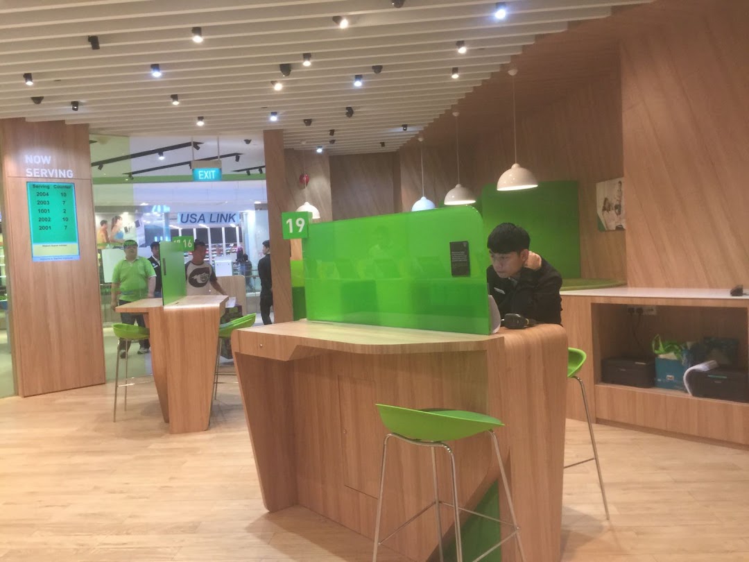 Interior of StarHub Westgate, featuring modern service counters and staff assisting customers.