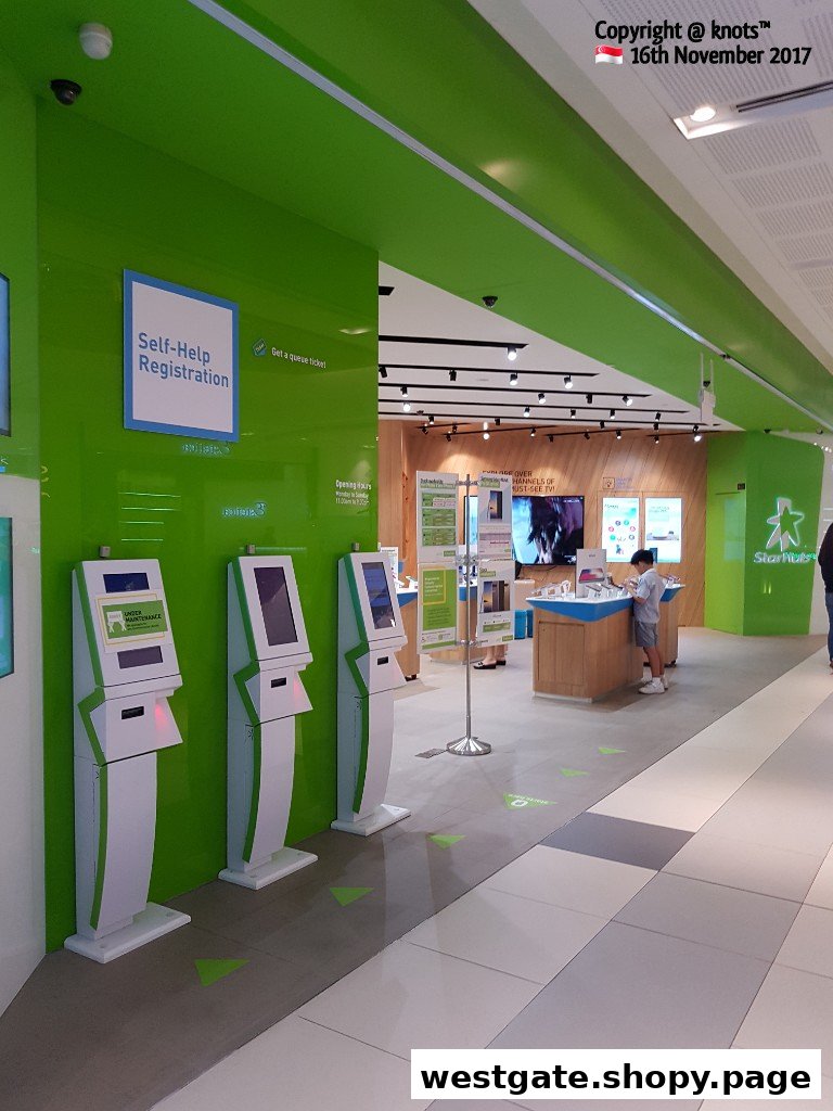 The StarHub Westgate store features self-help kiosks and a modern interior for customer service.