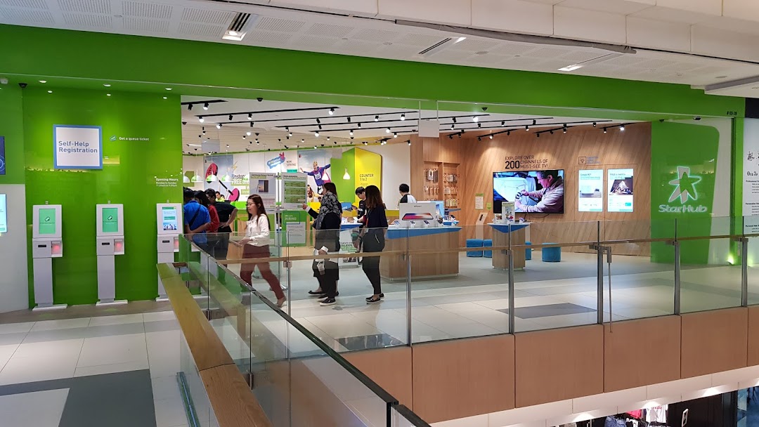 Interior view of StarHub Westgate, showing self-help kiosks, customer service counters, and product displays.