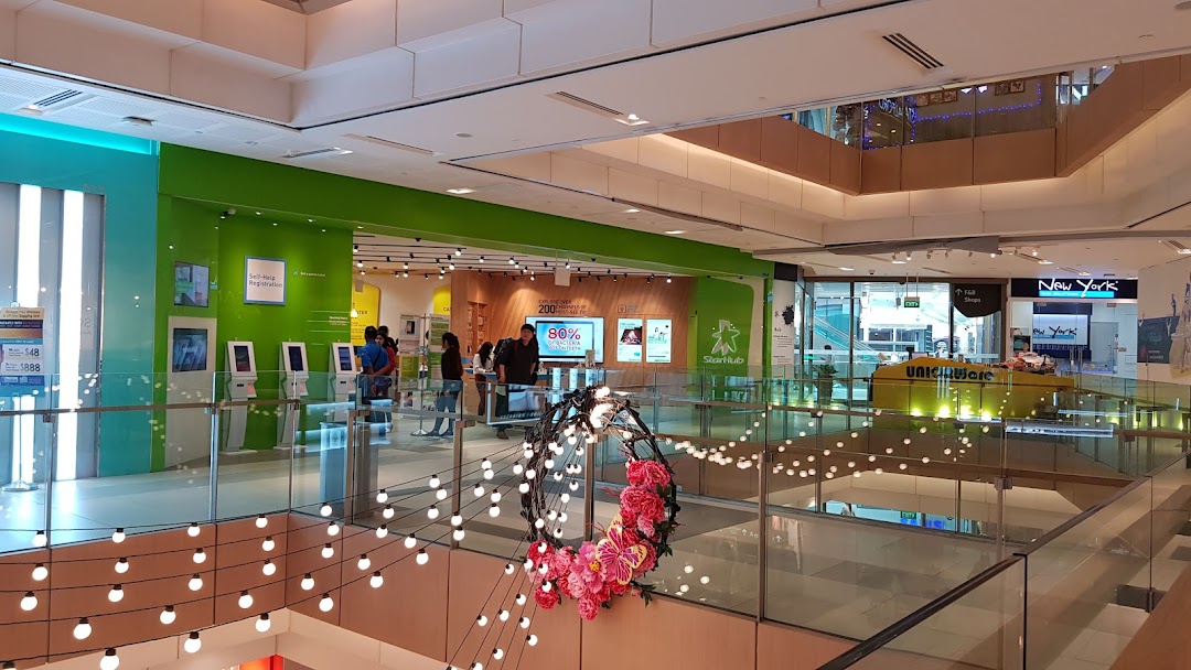 View of StarHub Westgate, a telecommunications shop, from an upper level of a bustling shopping mall.