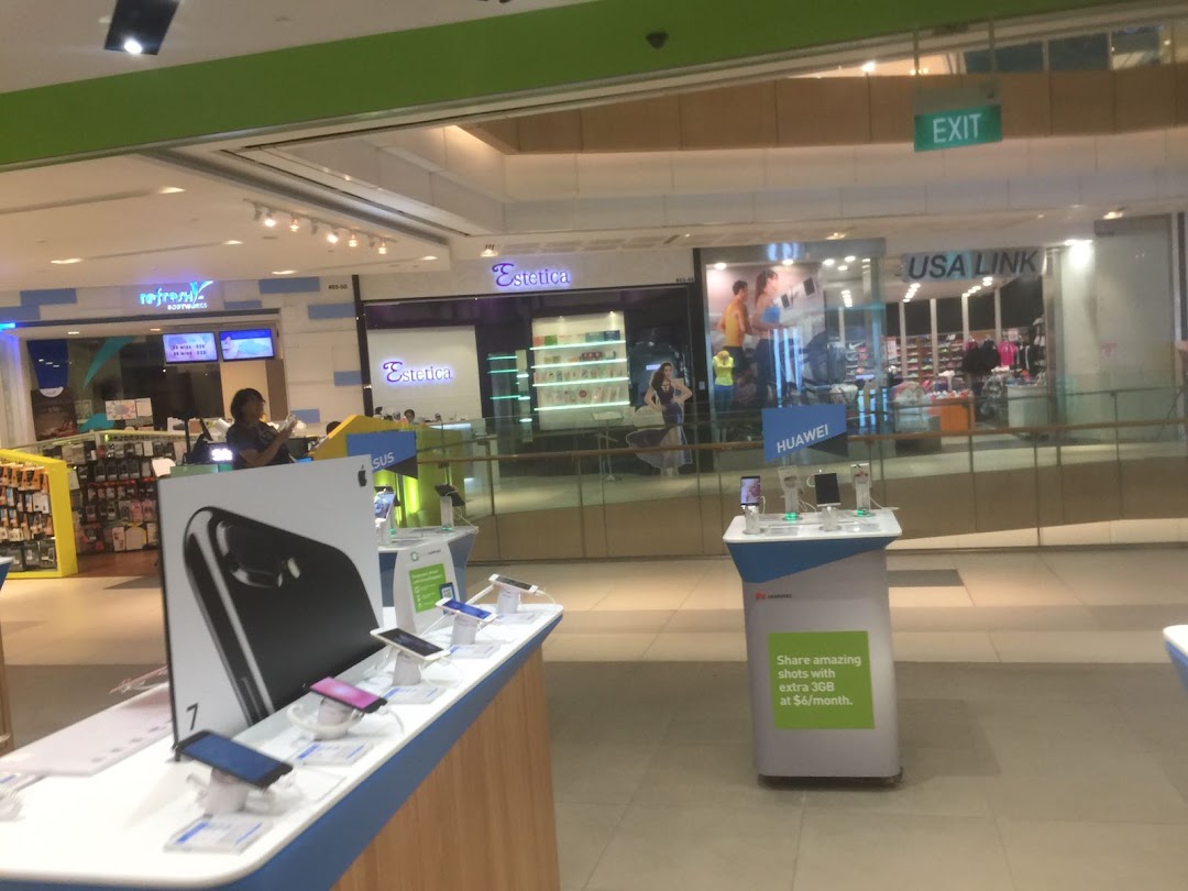 Interior view of a mall showcasing mobile phone displays and various retail shops.